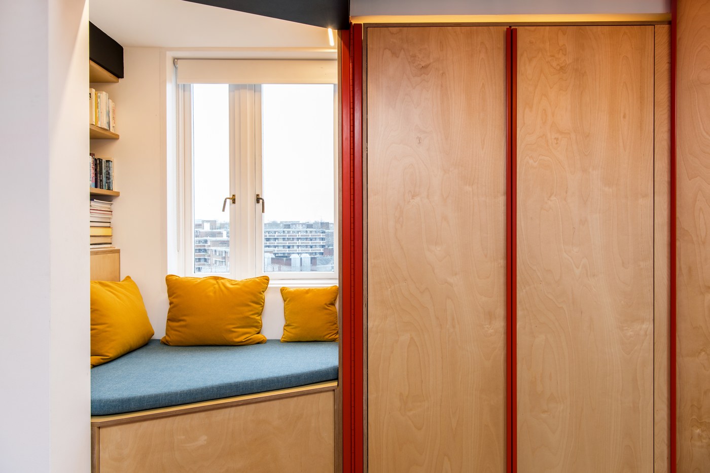 A deep-red feature against the birch-ply