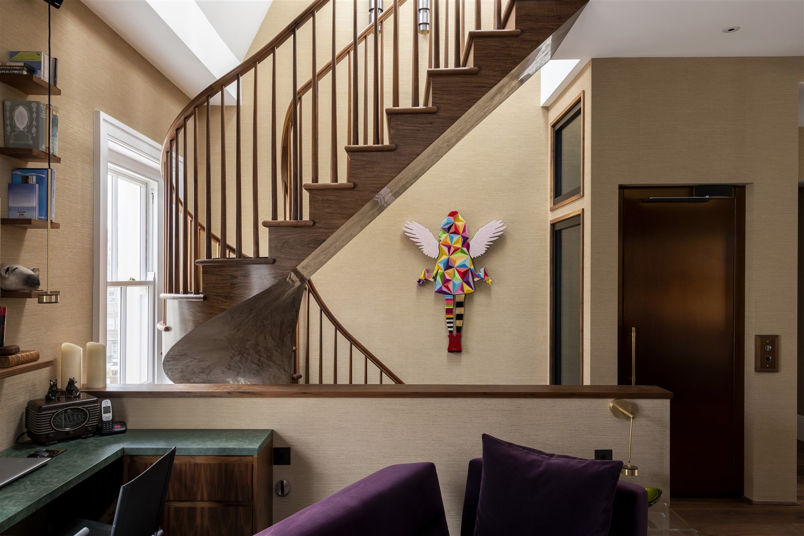 Sculptural walnut staircase within the Grade II-listed Randolph Avenue apartment in Maida Vale